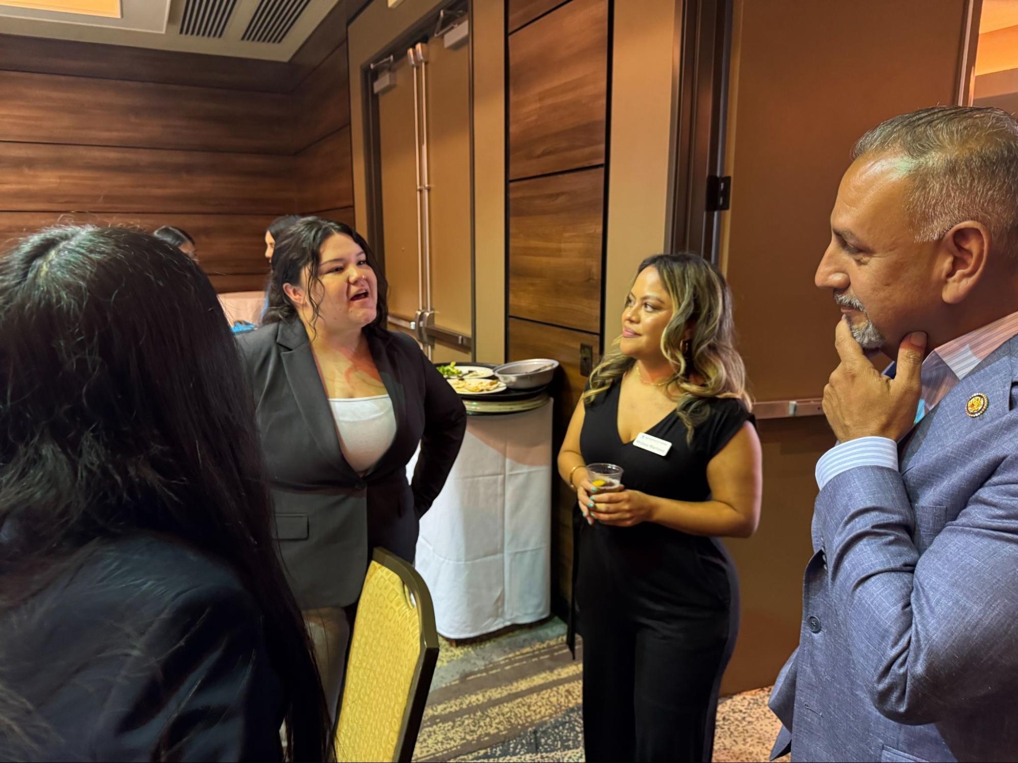 Autumn Davies shares their graduation plans and career goals with Congressman Gil Cisneros during the Legislative Luncheon.